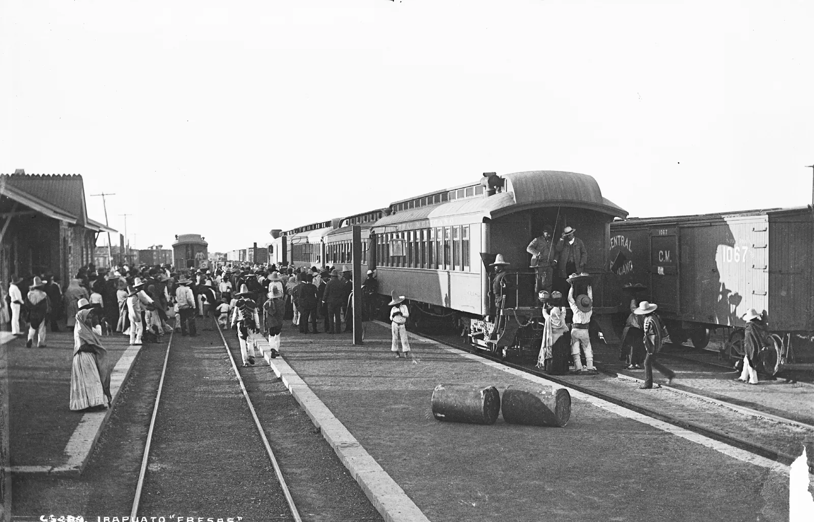 Vendors offering baskets of strawberries to train passengers at Irapuato station