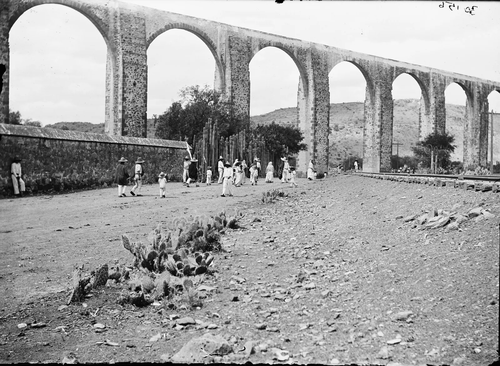 Arches of the Querétaro aqueduct with a railway track at their foot